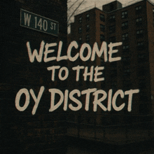a sign on a brick wall welcomes people to the oy district