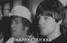 a black and white photo of two men standing next to each other with the words `` happy col ! xxx '' written on the bottom .