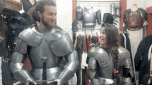 a man and a woman are dressed in armor and standing next to each other