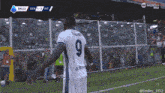 a soccer player with the number 9 on the back of his shirt