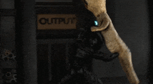 a blurred image of a person standing in front of a sign that says ' outfits ' on it