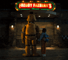 a freddy fazbear 's diner with a giant teddy bear standing in front of it