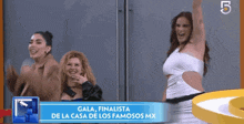 three women are standing in front of a sign that says gala finalista