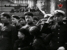 a black and white photo of soldiers saluting in front of a sign that says ' mah ' on it