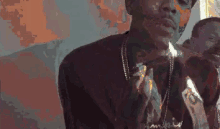 a pixelated image of a man wearing a necklace and a hat .