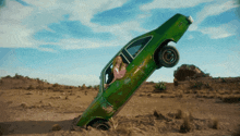 a green car that has the number 7 on the side