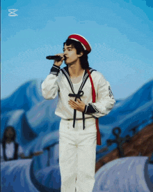 a man in a sailor 's uniform sings into a microphone