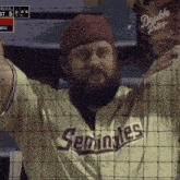 a man with a beard wearing a seminoles jersey