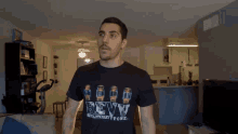 a man wearing a revv revolutionary tone t-shirt in a living room