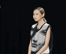 a woman wearing a black and white sweater with a microphone attached to it