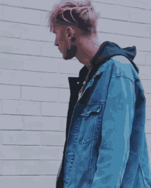a man with pink hair wearing a denim jacket