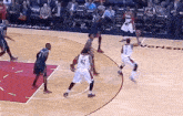 a group of basketball players are playing a game on a court sponsored by verizon