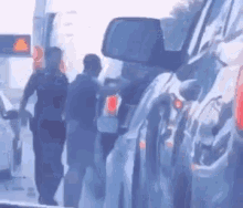 a group of police officers are standing next to each other on the side of the road .