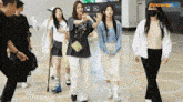a group of women are standing next to each other in a building .