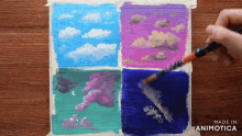 a painting of clouds is being painted with a brush