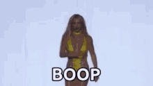 britney spears is wearing a yellow swimsuit and dancing on a stage .