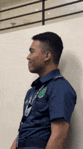 a man in a blue uniform with a lanyard that says college of criminology