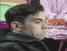 a man is making a funny face while sitting in front of a computer