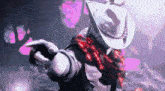 a man wearing a cowboy hat and a scarf is pointing at something .