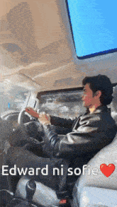 a man is driving a car with the words " edward ni sofie " on the screen