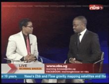 two men are sitting in front of a screen that says ' live morning breeze '