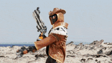 a person in a cowboy hat holding a gun