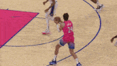 a basketball player wearing a pink jersey with the number 24