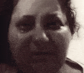 a close up of a woman 's face with a tear running down her cheek .