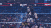 a woman in a wrestling ring with a sign that says roxanne perez on it