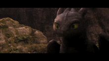 toothless from how to train your dragon looks at the camera with a smile on his face