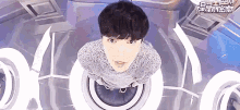 a man in a sweater is looking up at the camera .