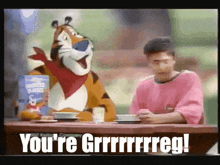 a man sitting at a table with a box of tony the tiger cereal