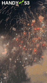 fireworks are displayed in the night sky and the number 53 is visible