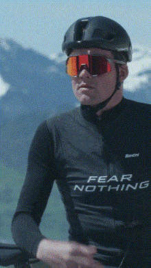 a man wearing a black shirt that says fear nothing on it