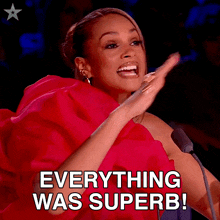 a woman in a red dress applauds and says " everything was superb "