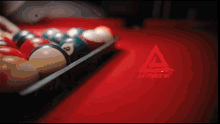 pool balls in a tray on a pool table with a reebok logo