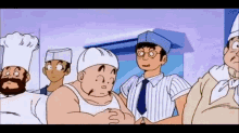 a group of men in chef hats are standing next to each other .