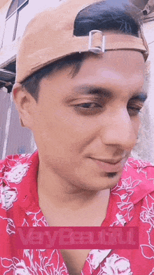 a man wearing a hat and a red shirt with a very beautiful watermark
