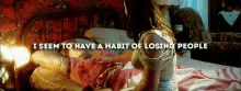a woman laying on a bed with the words i seem to have a habit of losing people