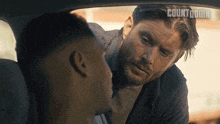a man talking to another man in a car with the word countdown on the bottom right