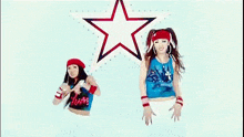 two women are dancing in front of a blue background with a red and white star .