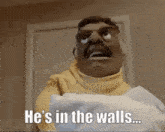 a man with a mustache is holding a roll of toilet paper .