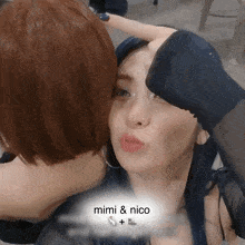 a woman kissing another woman 's forehead with the words mimi & nico on the bottom right