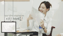 a group of girls sit at desks in a classroom with twice written on the top left
