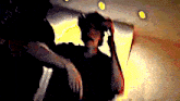 a blurry picture of a person holding another person 's head