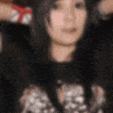 a blurry picture of a woman 's face with a polka dot shirt