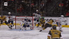 a hockey game is being played in front of a caesars advertisement