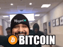 a man wearing a black beanie with the word bitcoin written on it