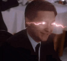 a man in a suit and tie has a lightning bolt coming out of his eyes