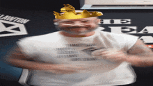 a man with a crown on his head is wearing a lawton shirt